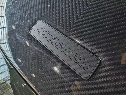 McLaren 570GT 2017 2018 2019 & 540C 570S 2016 2017 2018 2019 2020 & 600LT 2019 2020 & 620R 2021 & 675LT 650S 2015 2016 & 720S 2018 2019 2020 2021 2022 2023 & 750S 2024-ON & 765LT 2021 2022 & Artura 2023-ON & Elva 2021 & GT 2020 2021 2022 2023 & GTS 2025-ON & MP4-12C 2012 2013 2014 & P1 2013 2014 2015 & Senna 2019 2020 with Aftermarket Parts - Emblem Badge Carbon Fiber